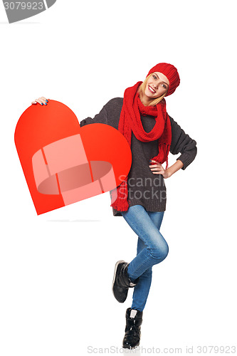 Image of Full length girl holding up a red cardboard heart