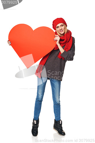 Image of Full length girl holding up a red cardboard heart