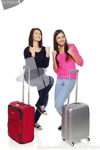 Image of Two friends girls with travel suitcases