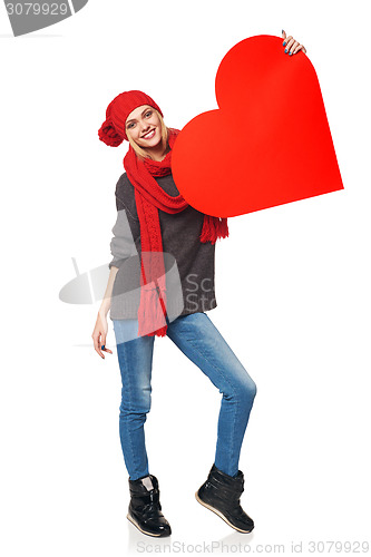 Image of Full length girl holding up a red cardboard heart