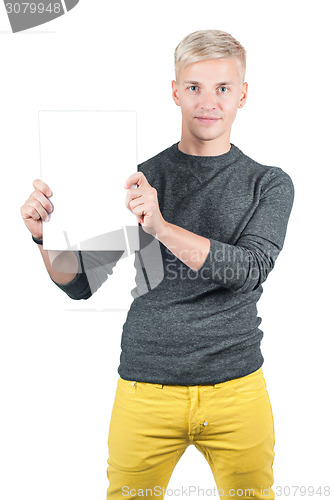 Image of Smiling young casual man holding blank paper
