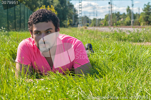 Image of Handsome man in pink near railway 