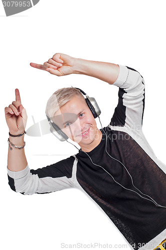 Image of Young handsome man dancing with headphones 