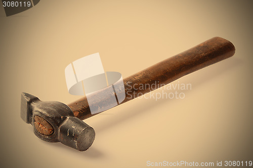 Image of old metal hammer with wooden handle