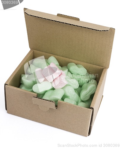 Image of packaging box with green foam and some pink ones