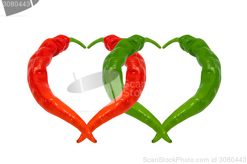 Image of Red and green chili peppers in love. Hearts composed of peppers.