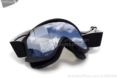 Image of Ski goggles with reflection of cloudy mountains