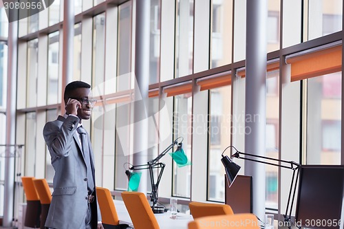 Image of African American businessman talk by phone