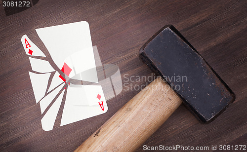 Image of Hammer with a broken card, ace of diamonds