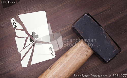 Image of Hammer with a broken card, ace of clubs