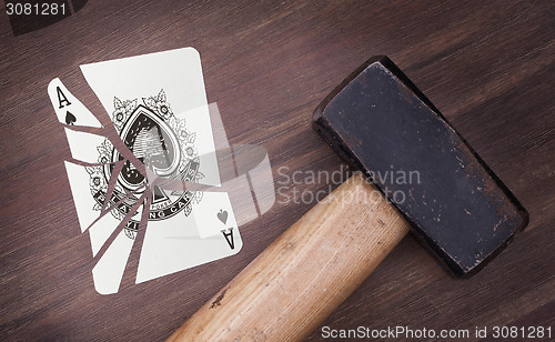 Image of Hammer with a broken card, ace of spades