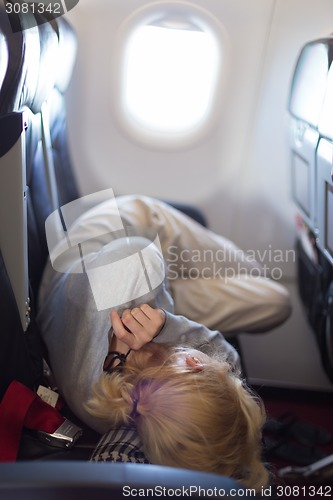 Image of Young woman sleeping on airplane