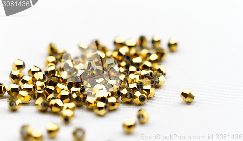 Image of Beautiful golden glass beads closeup on white background