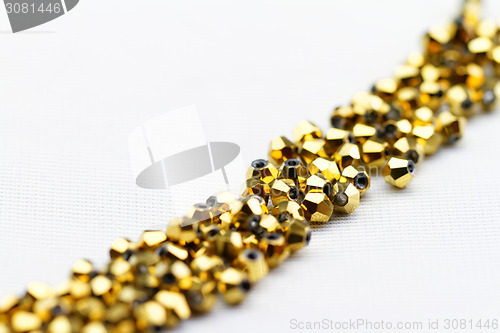 Image of Beautiful golden glass beads closeup on white background