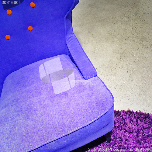 Image of Fancy blue armchair on purple carpet