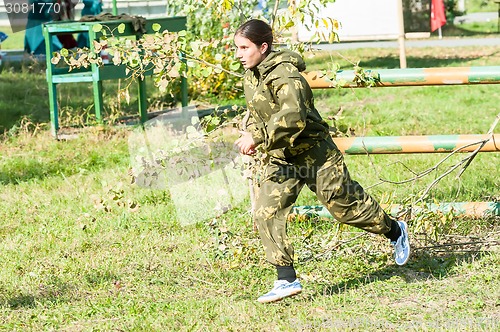 Image of Teenage girl jumped through obstacle