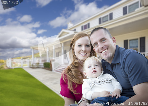 Image of Young Military Family in Front of Beautiful House