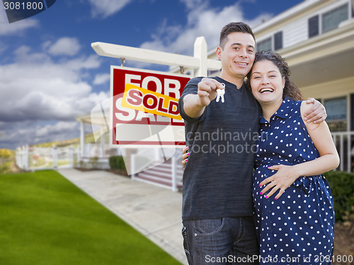 Image of Hispanic Couple with Keys In Front of Home and Sign