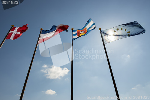 Image of Blue sky with four flags