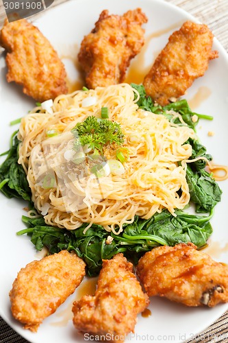 Image of Chicken Wings with Noodles and Spinach