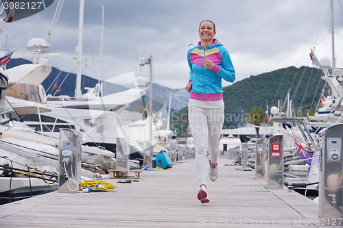 Image of woman jogging in marina