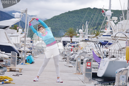 Image of woman jogging in marina