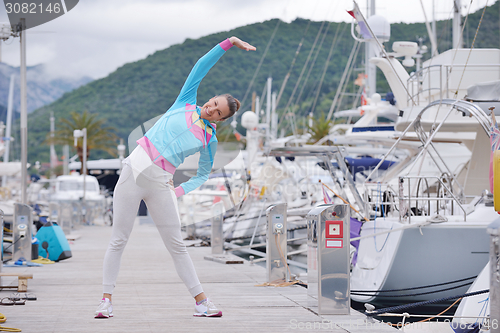 Image of woman jogging in marina