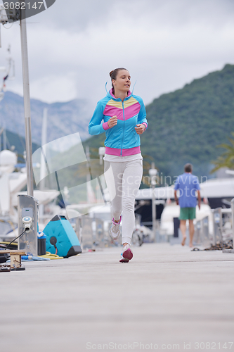 Image of woman jogging in marina