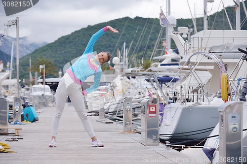 Image of woman jogging in marina