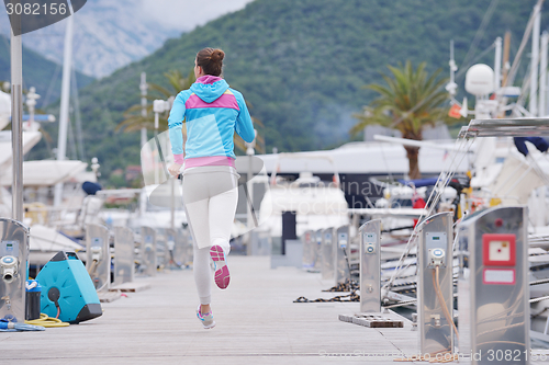 Image of woman jogging in marina