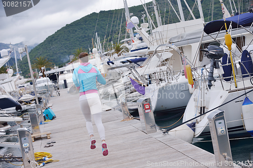 Image of woman jogging in marina