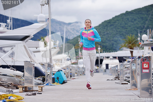 Image of woman jogging in marina