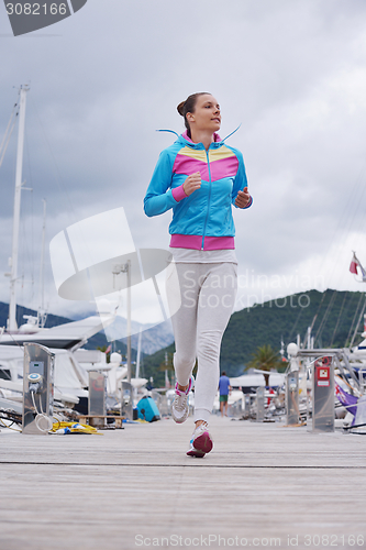 Image of woman jogging in marina