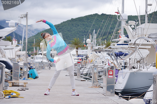 Image of woman jogging in marina