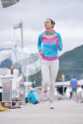 Image of woman jogging in marina
