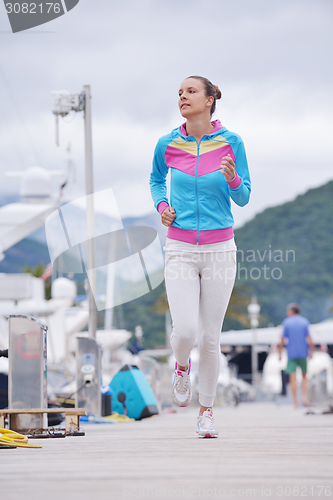 Image of woman jogging in marina