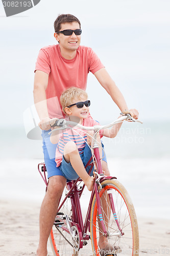 Image of family biking at the beach