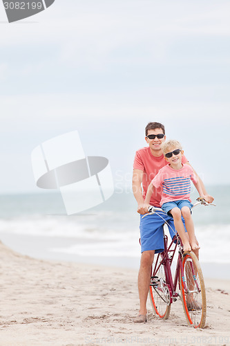 Image of family biking at the beach