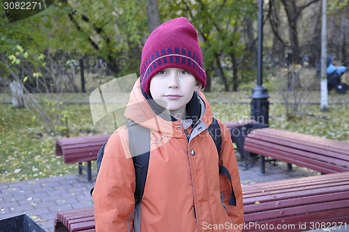 Image of the teenage boy's portrait in autumn park.