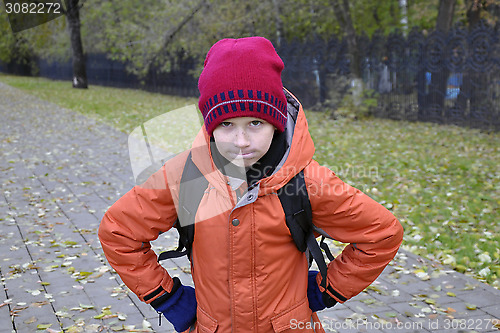 Image of the teenage boy's portrait in autumn park.