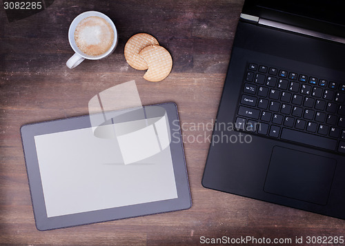 Image of Tablet touch computer gadget on wooden table