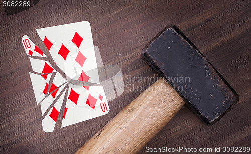 Image of Hammer with a broken card, ten of diamonds