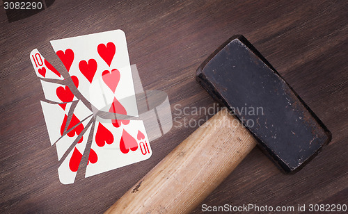 Image of Hammer with a broken card, ten of hearts