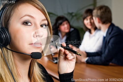 Image of Beautiful business woman with headset