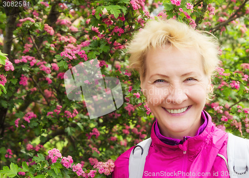 Image of Portrait of the sports woman of average years at a  blossoming h