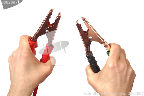 Image of Hands with jumper cables on white