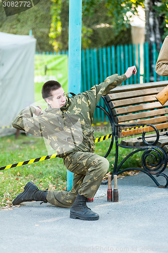 Image of Boy throws hand grenade