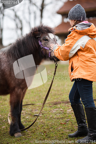 Image of Little girl with pony