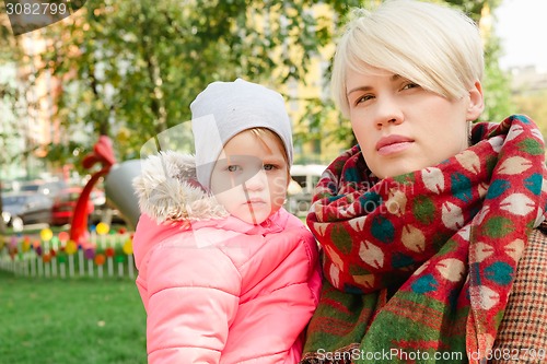 Image of Beautiful Mother And Baby outdoors.