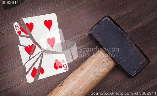 Image of Hammer with a broken card, six of hearts